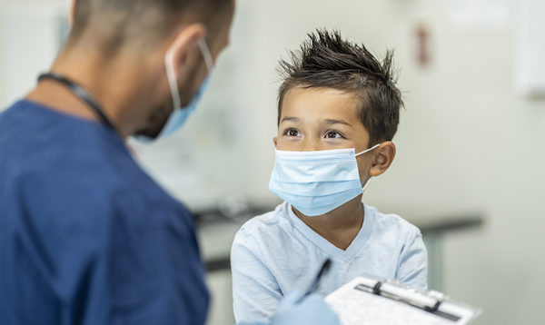 Young Boy Wearing A Mask At A Doctors Appointment